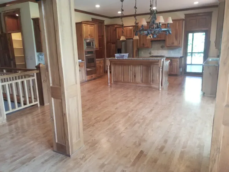 A kitchen with hardwood floors and a large island