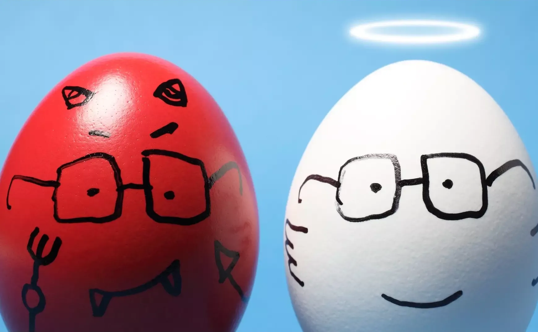 Red egg, devil with glasses; white egg, angel with glasses and halo.