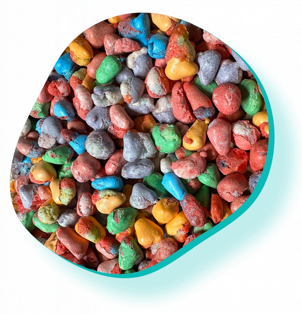 A pile of colorful candy in a purple circle on a white background.