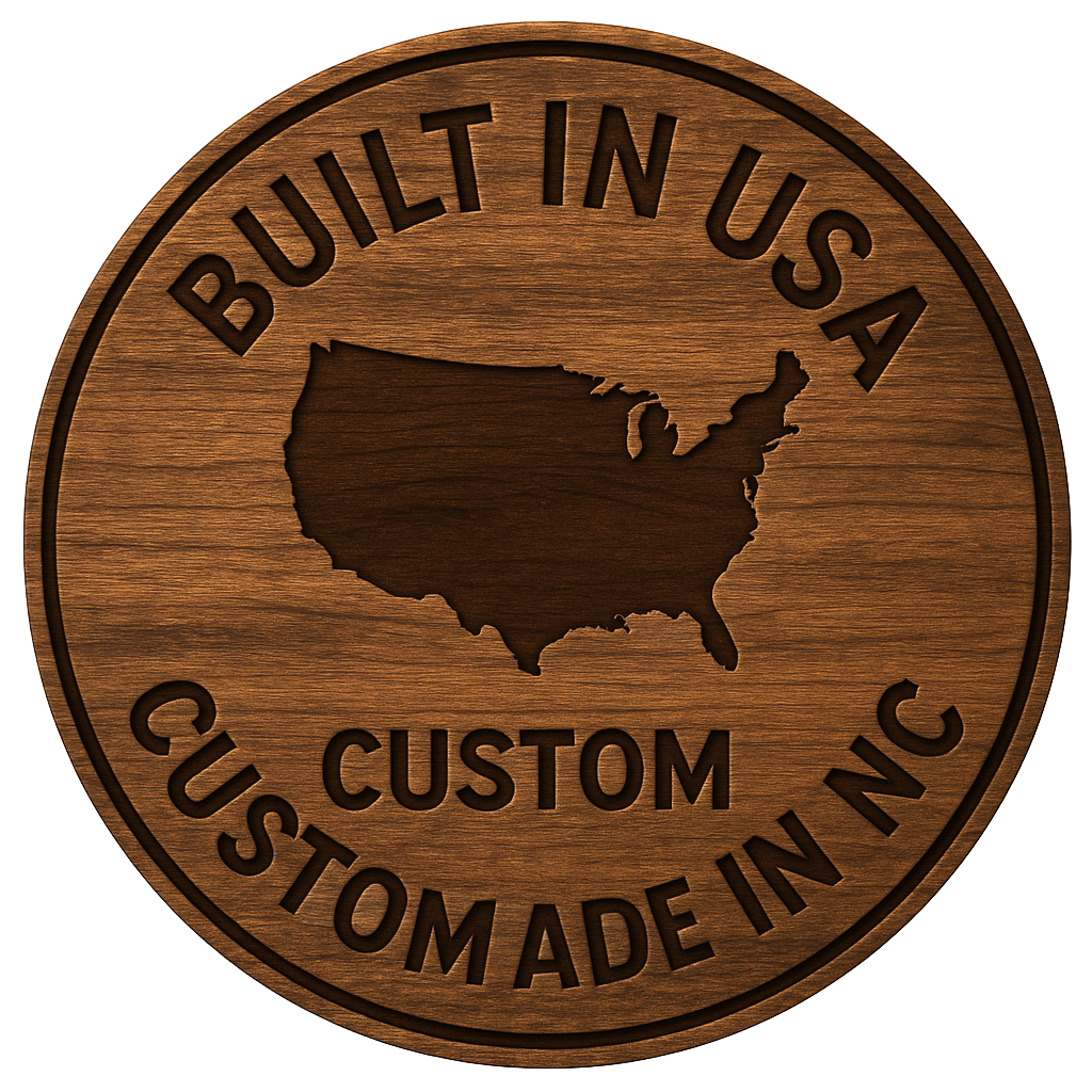 Circular wooden emblem with “BUILT IN USA”, map of the USA, “CUSTOM MADE IN NC”.