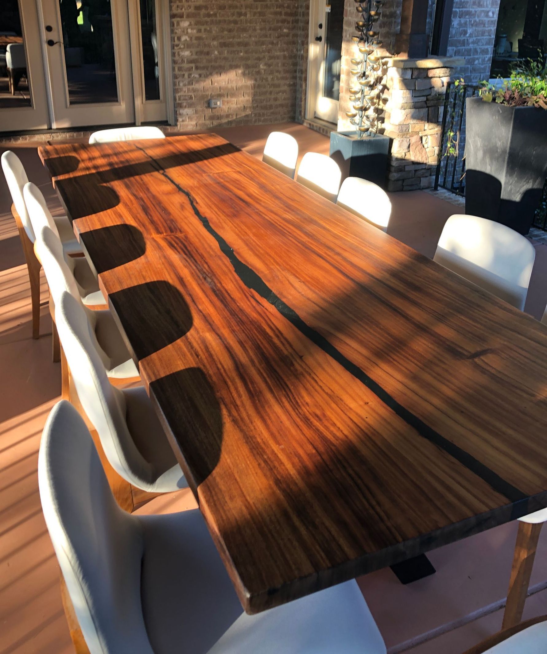 A long wooden table with a lot of chairs around it