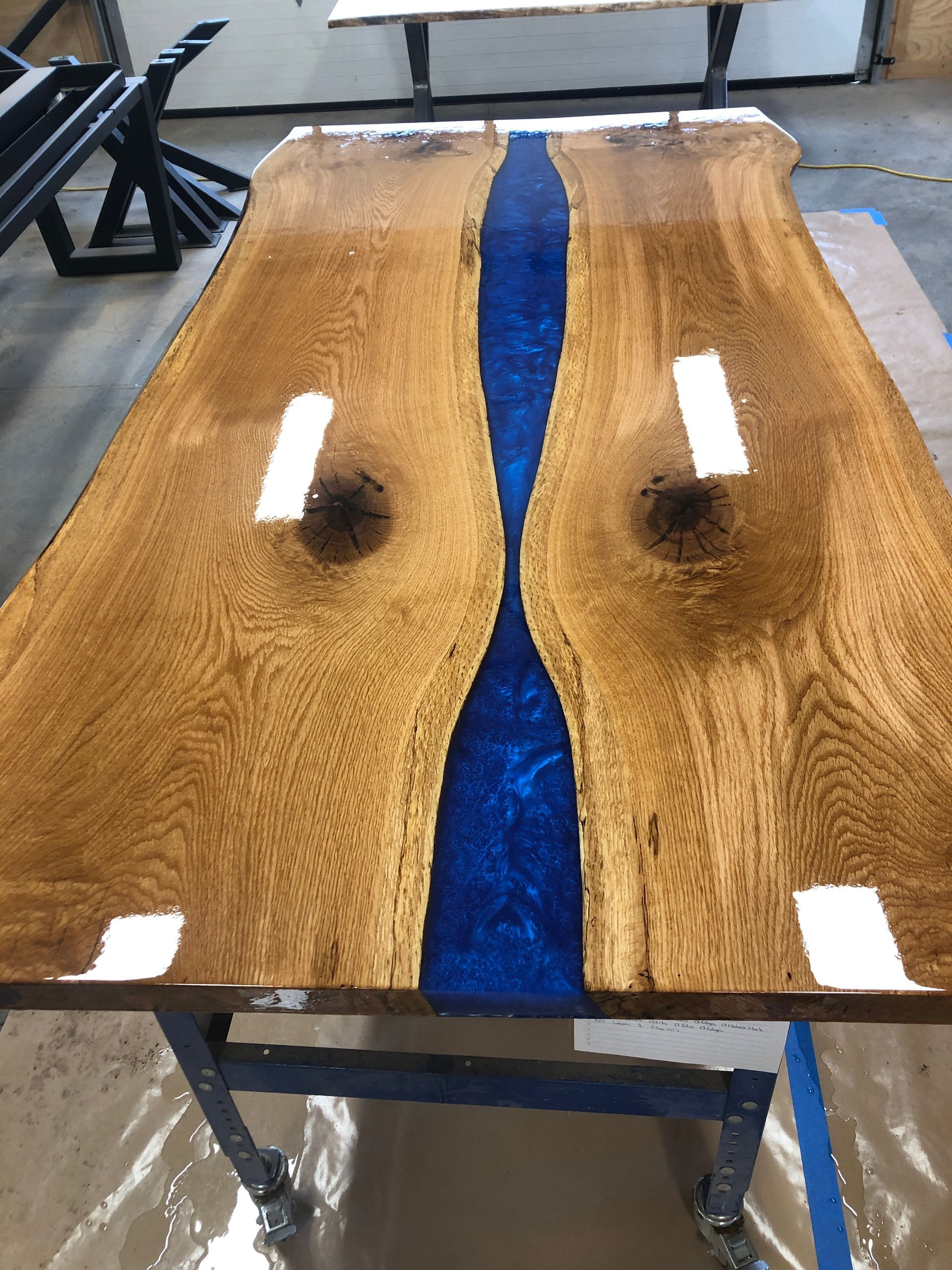 A wooden table with a blue river in the middle of it.