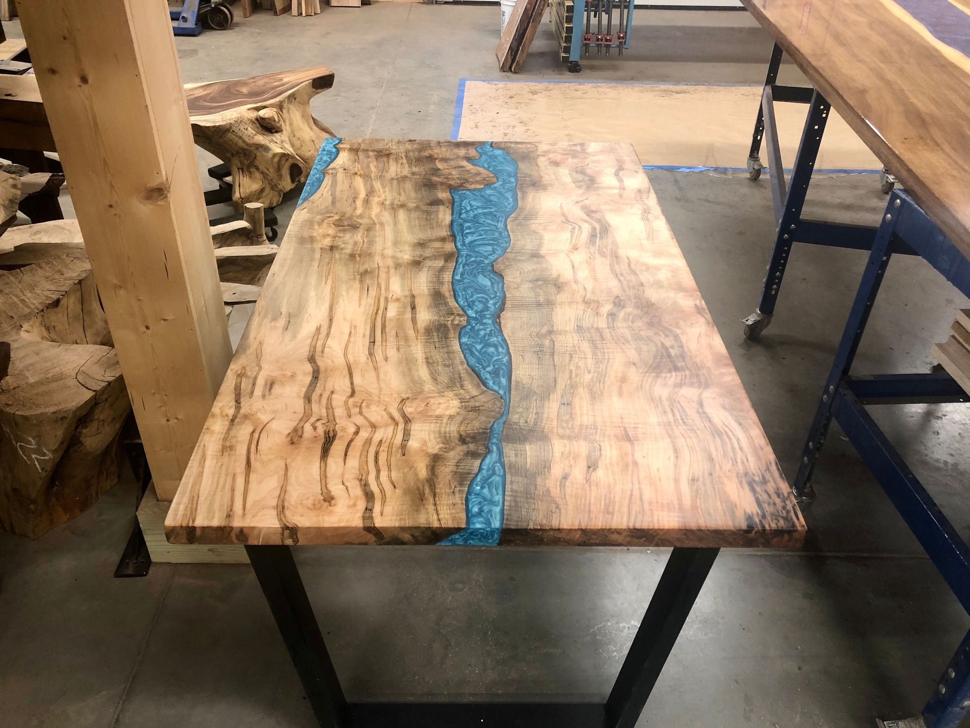 A wooden table with a river in the middle of it.
