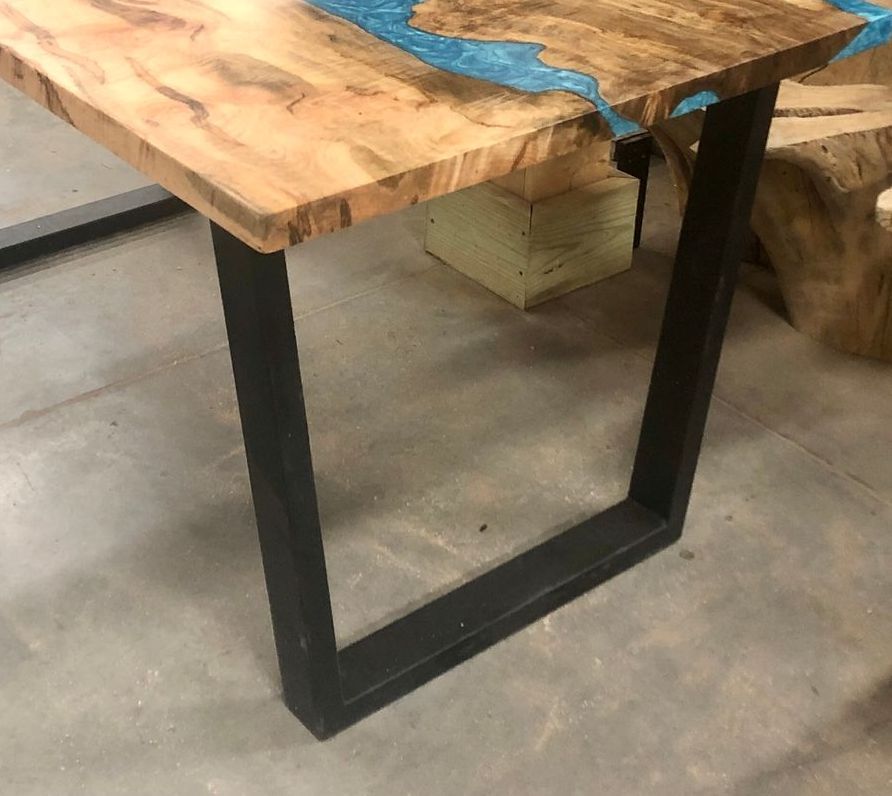A wooden table with a blue river in the middle of it.