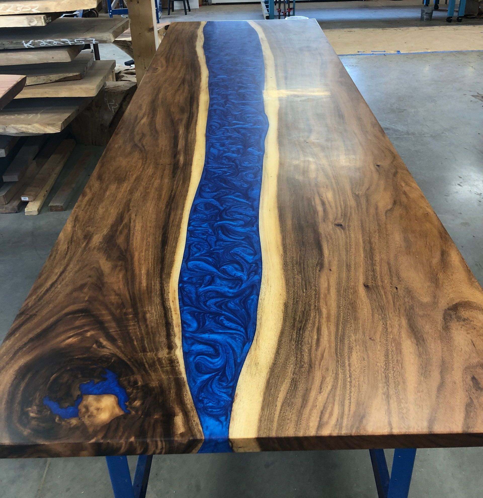 A wooden table with a blue river in the middle