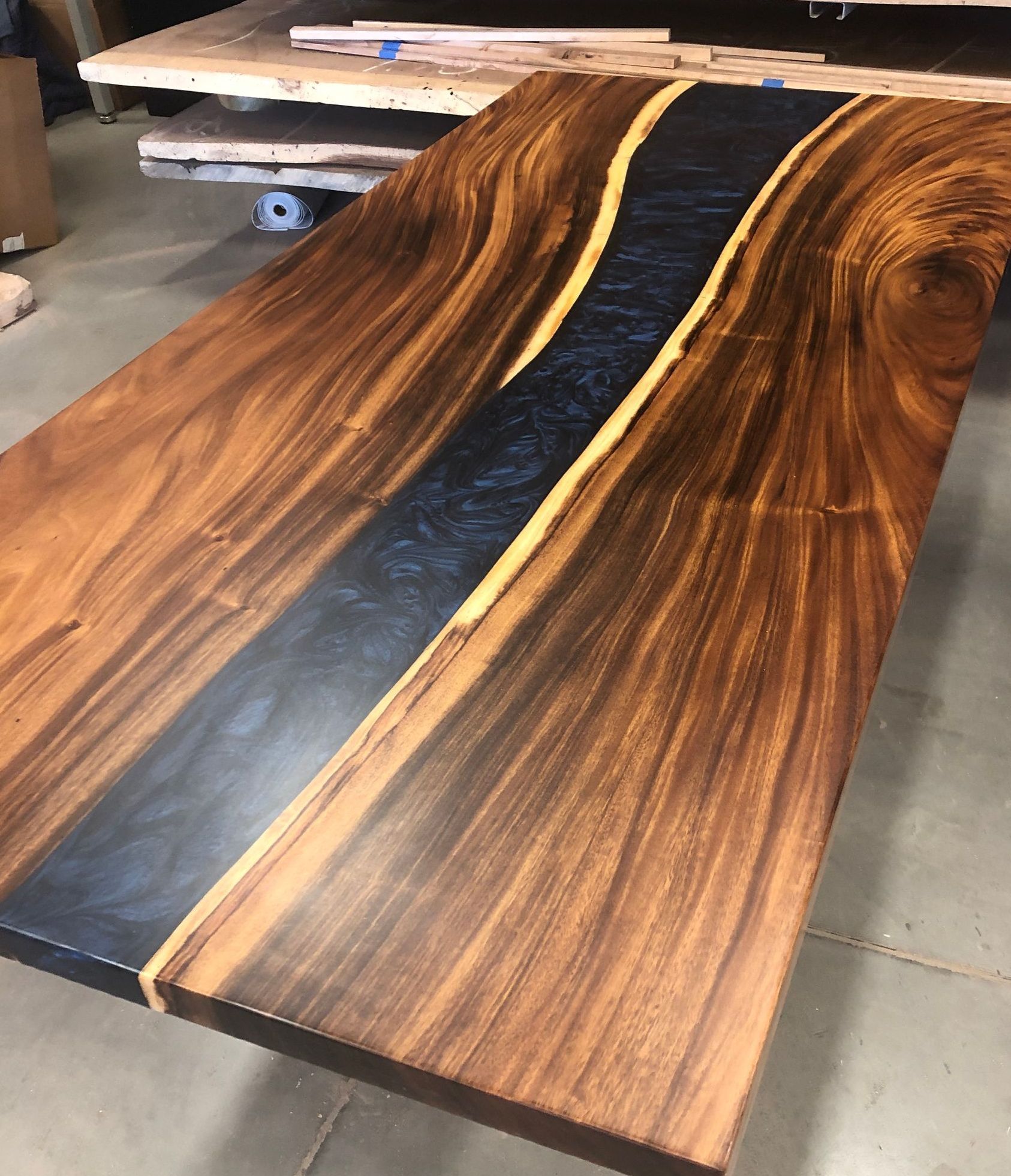 A wooden table with a river running through it