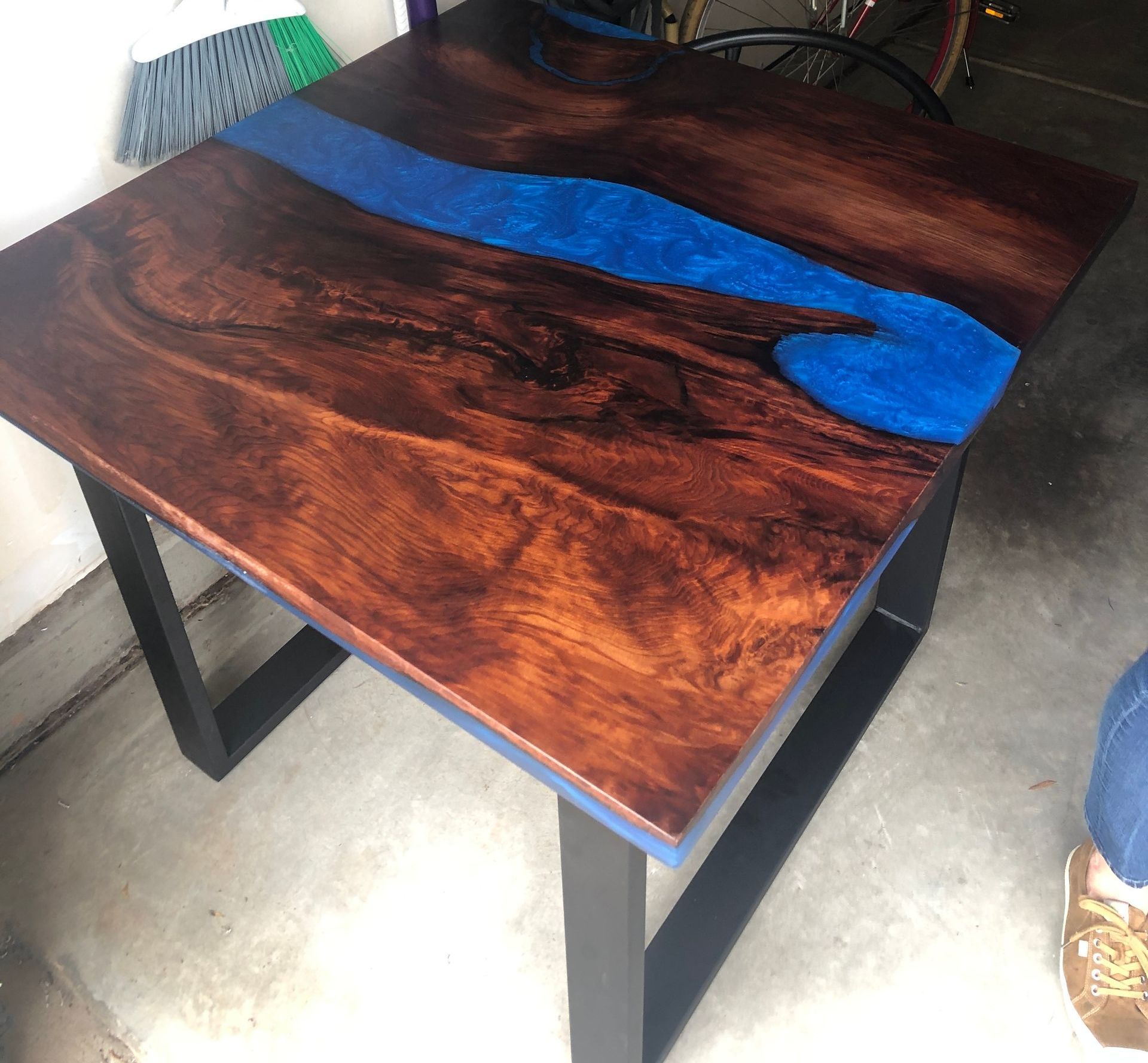 A wooden table with a blue river in the middle of it.