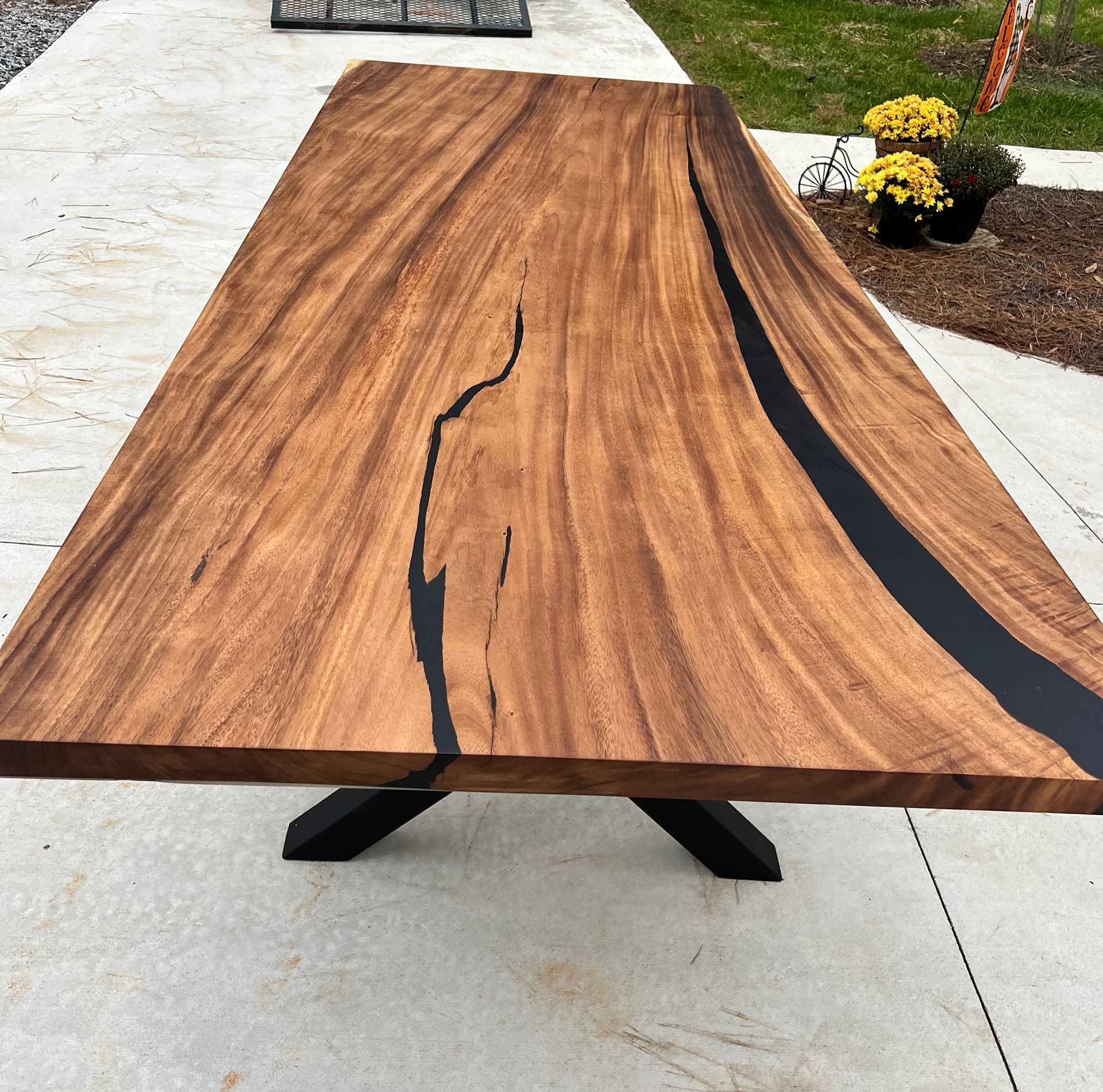 A kitchen with a long wooden table and stools