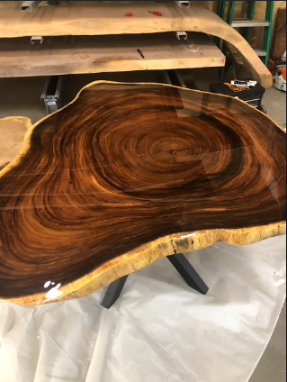 A large piece of wood is sitting on top of a white cloth.