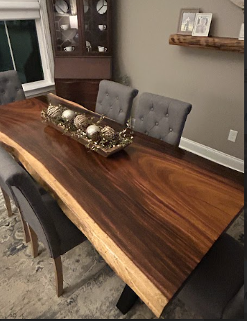 A wooden table with a bowl of balls on it in a dining room.