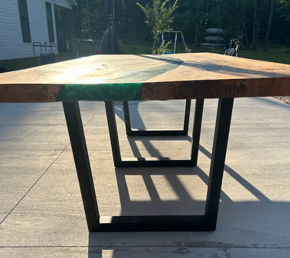 A wooden table with a blue river in the middle of it.