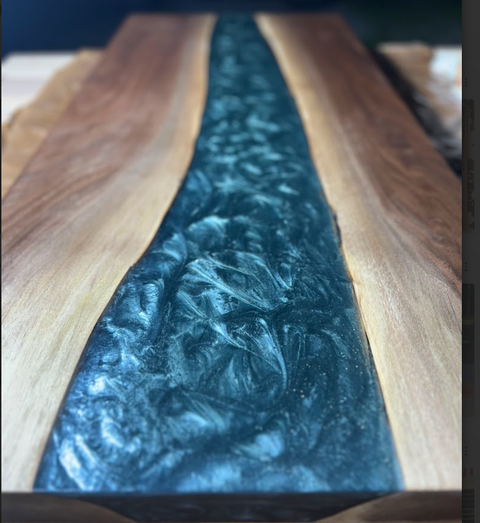 A wooden table with a blue river running through it.