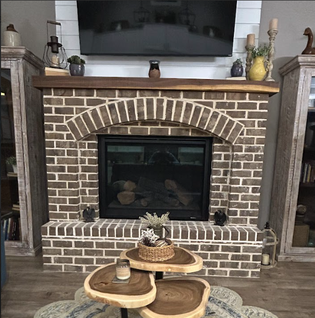 A living room with a fireplace and a flat screen tv