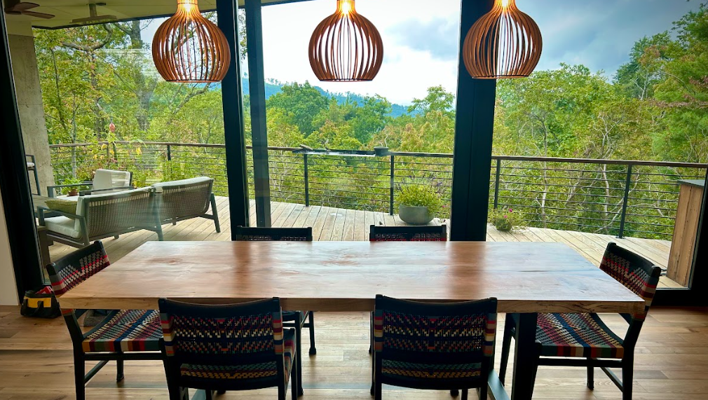A long wooden table with a lot of chairs around it