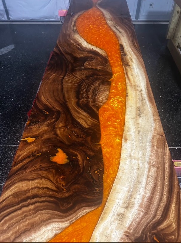 A wooden table with a blue river in the middle