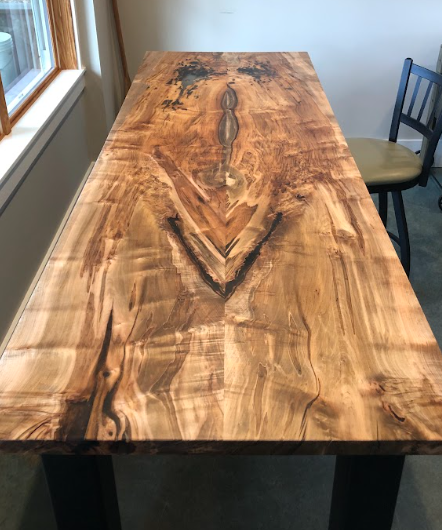 A wooden table with a river in the middle of it, in Asheville, NC