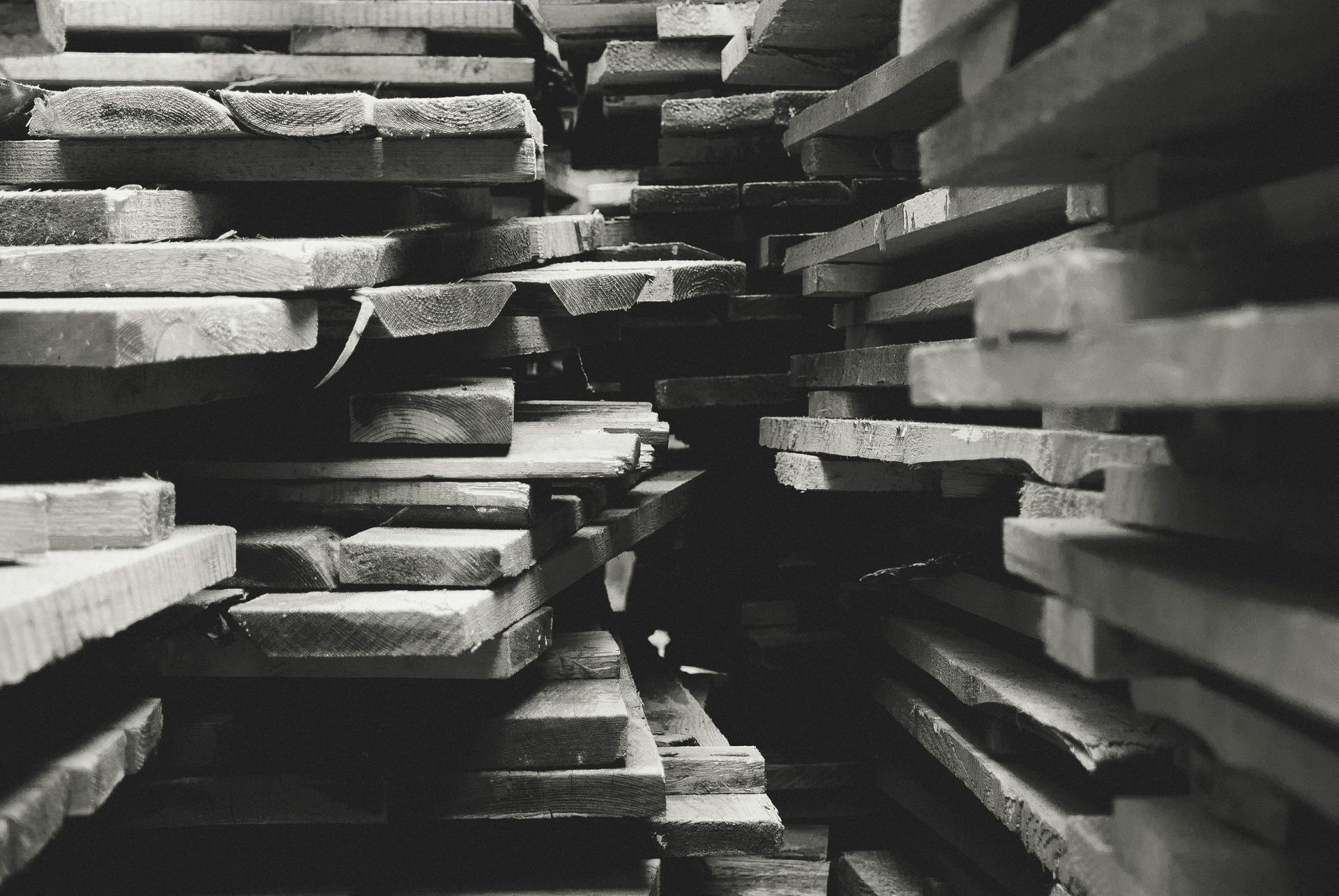 A black and white photo of a pile of wood.