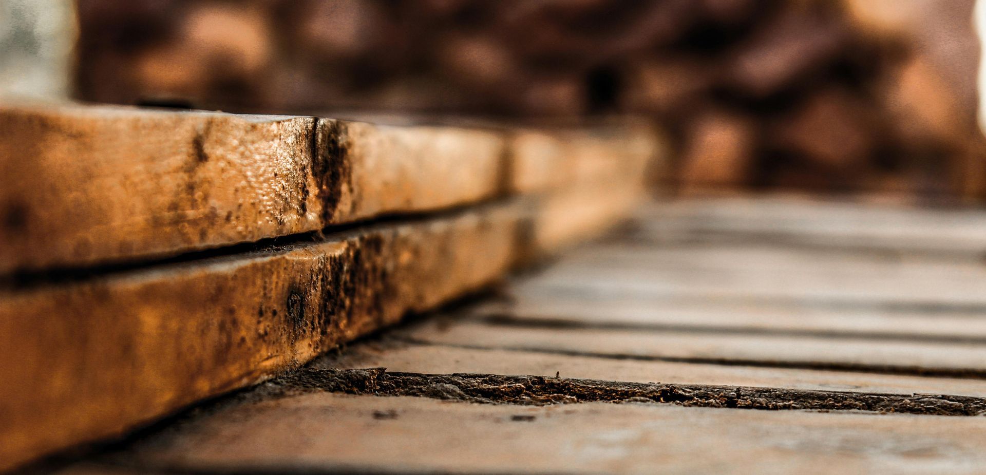 A close up of a stack of wooden boards on a wooden floor.