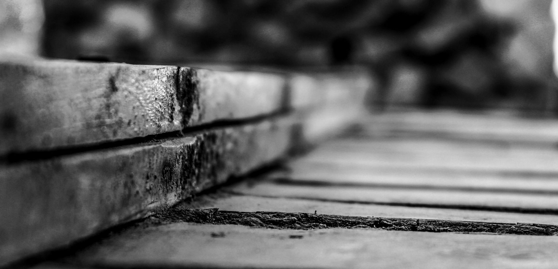 A black and white photo of a wooden bridge.