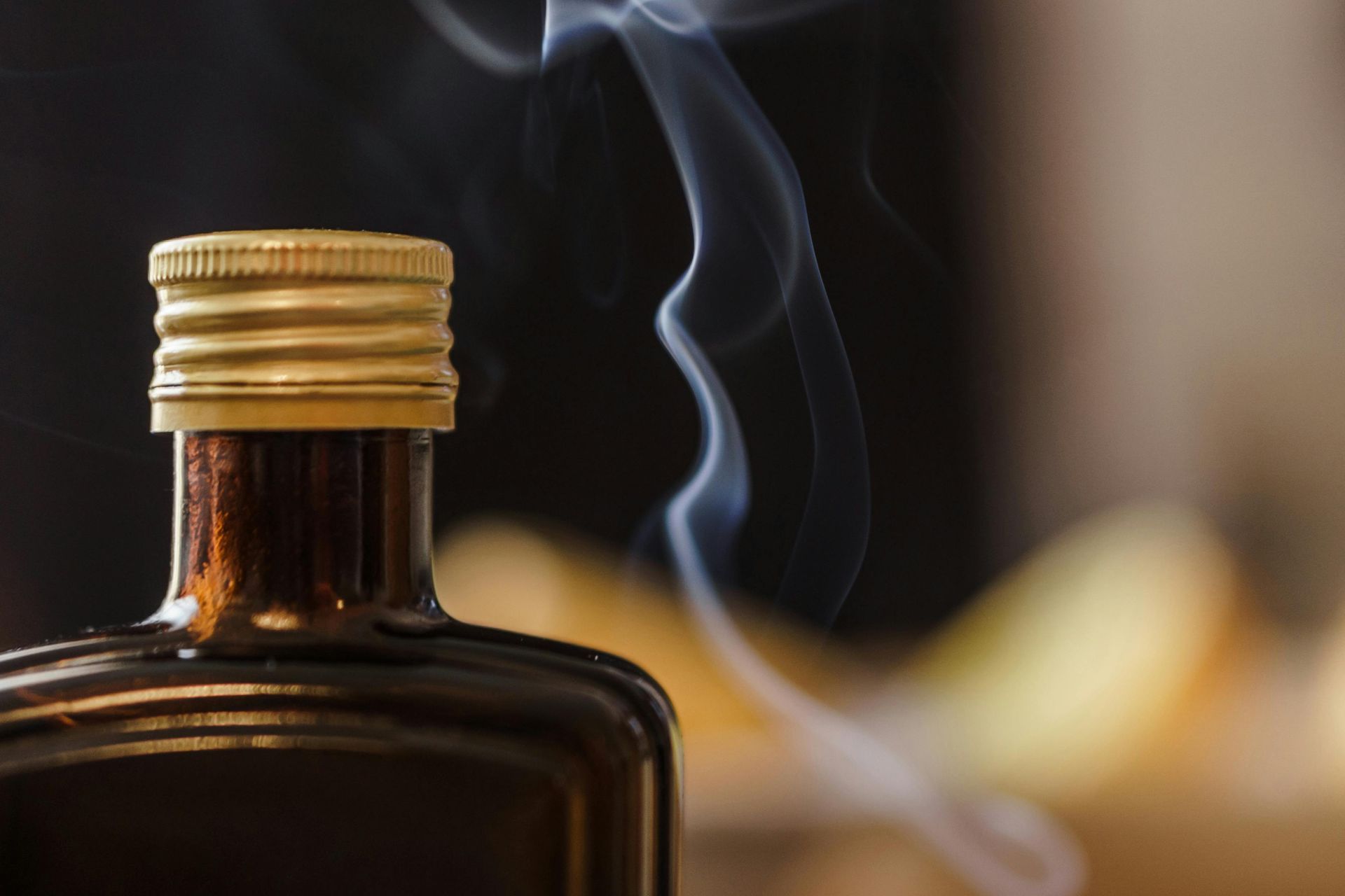 A close up of a bottle with smoke coming out of it