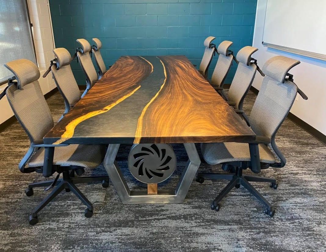 Conference table with a road design, surrounded by grey office chairs.