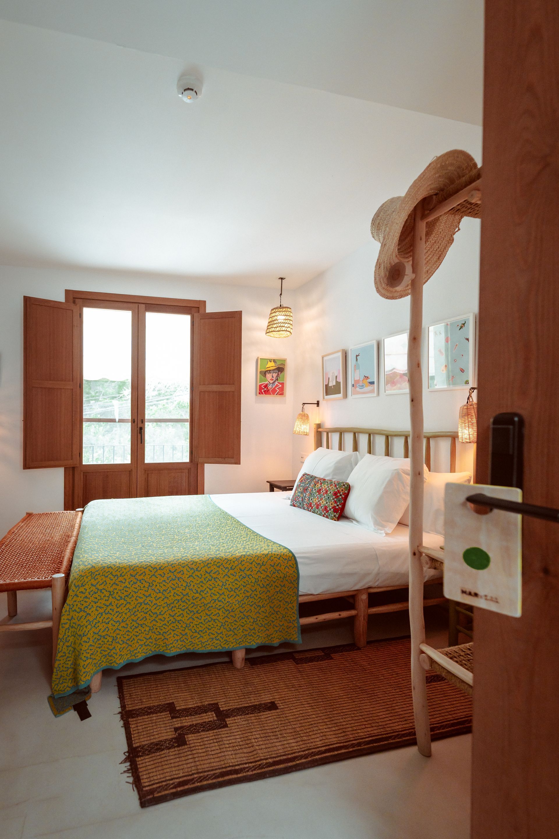 A bedroom with a bed and a window with shutters