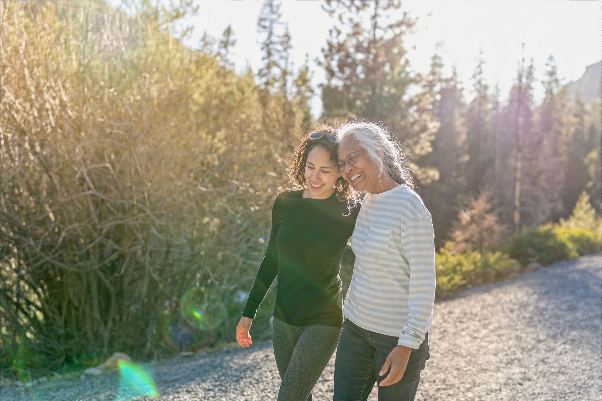 A group of elderly people are hiking in a field.