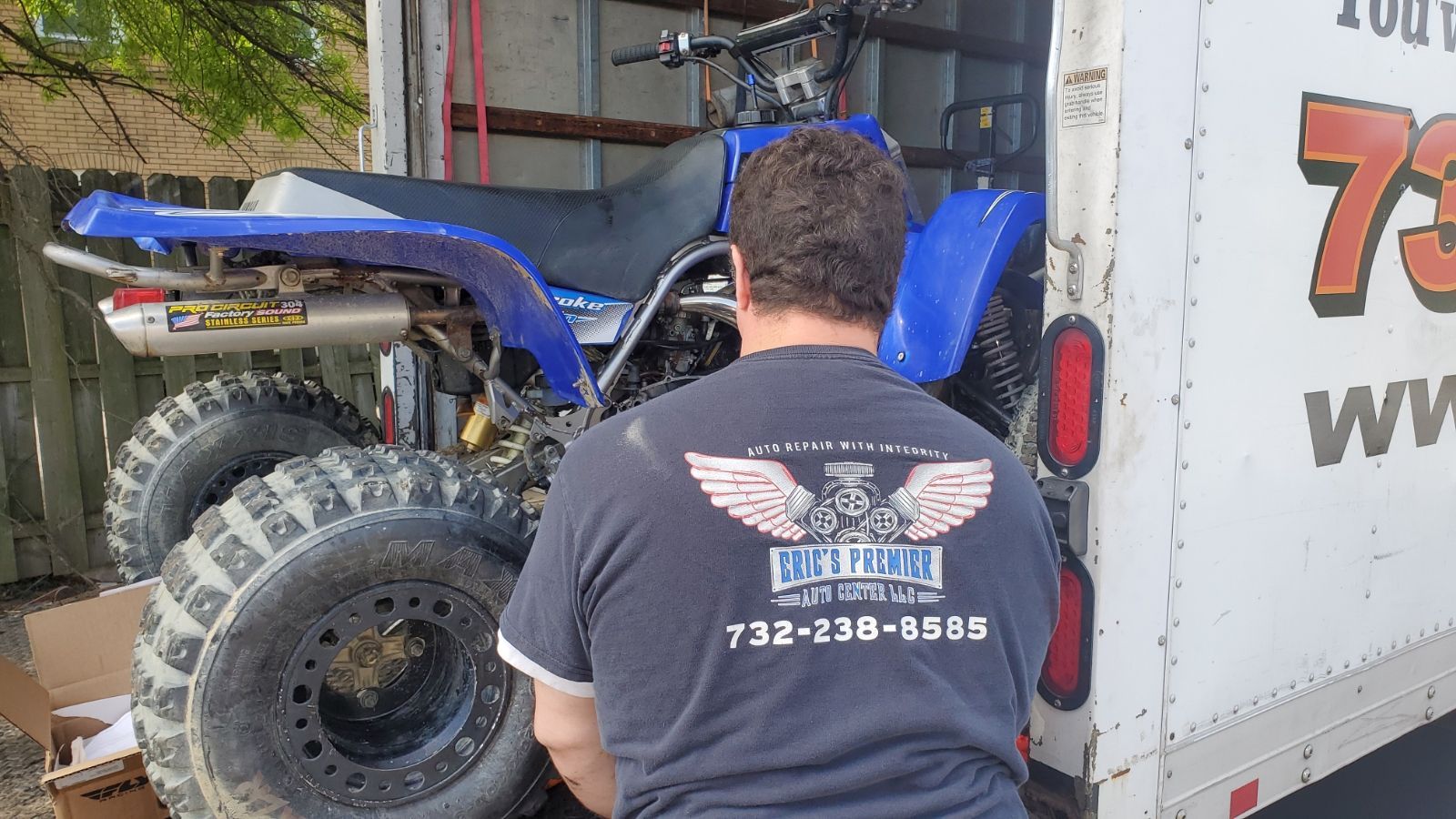 Man Loading ATV Onto Truck | Eric's Premier Auto Center