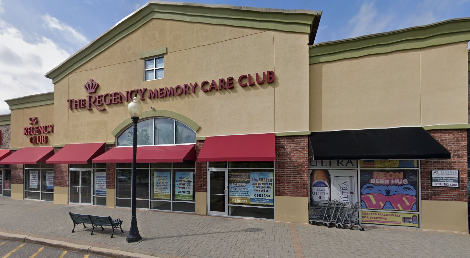 The Regency Ballroom entrance with a red awning, glass doors, and benches on a paved sidewalk with a fire lane marking.