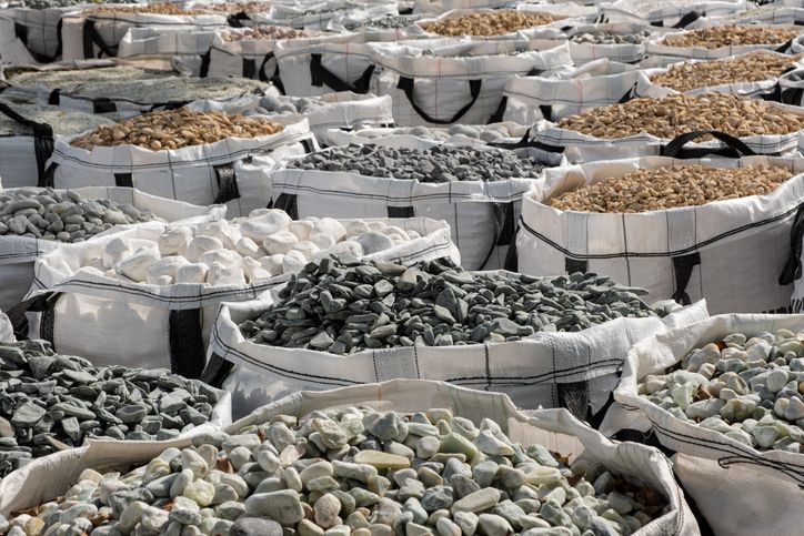 A lot of one cubic meter bags filled with variations of garden decorative crushed stones