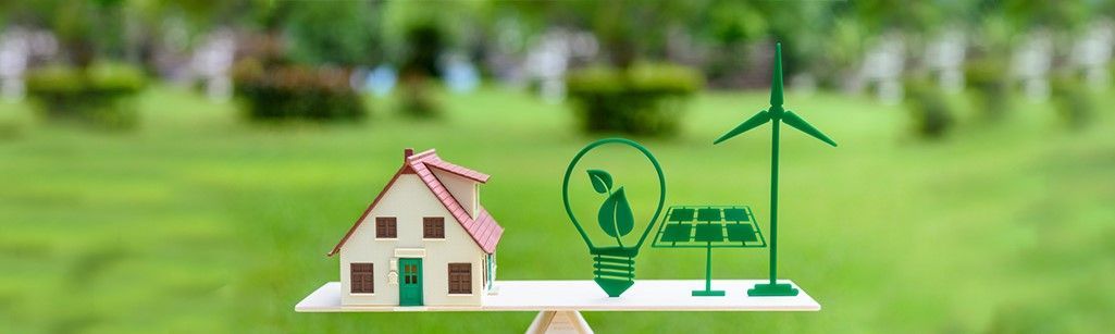 House with light bulb and solar panel to signify going green.