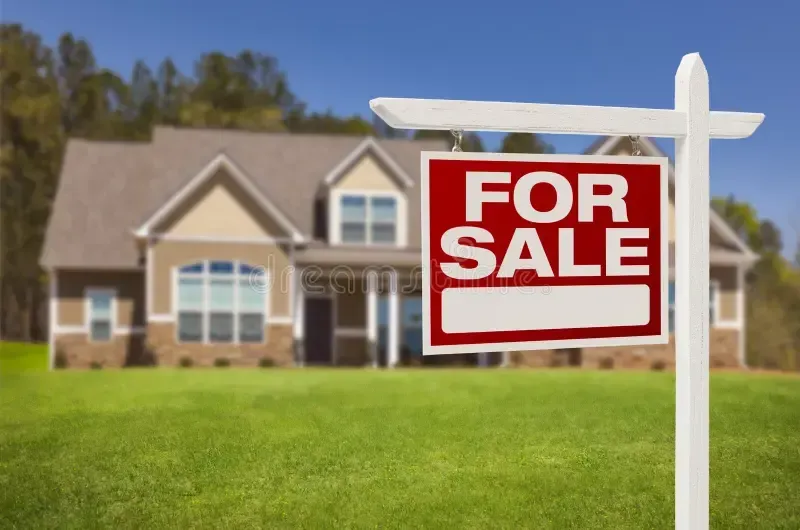 For sale sign in front of a house.