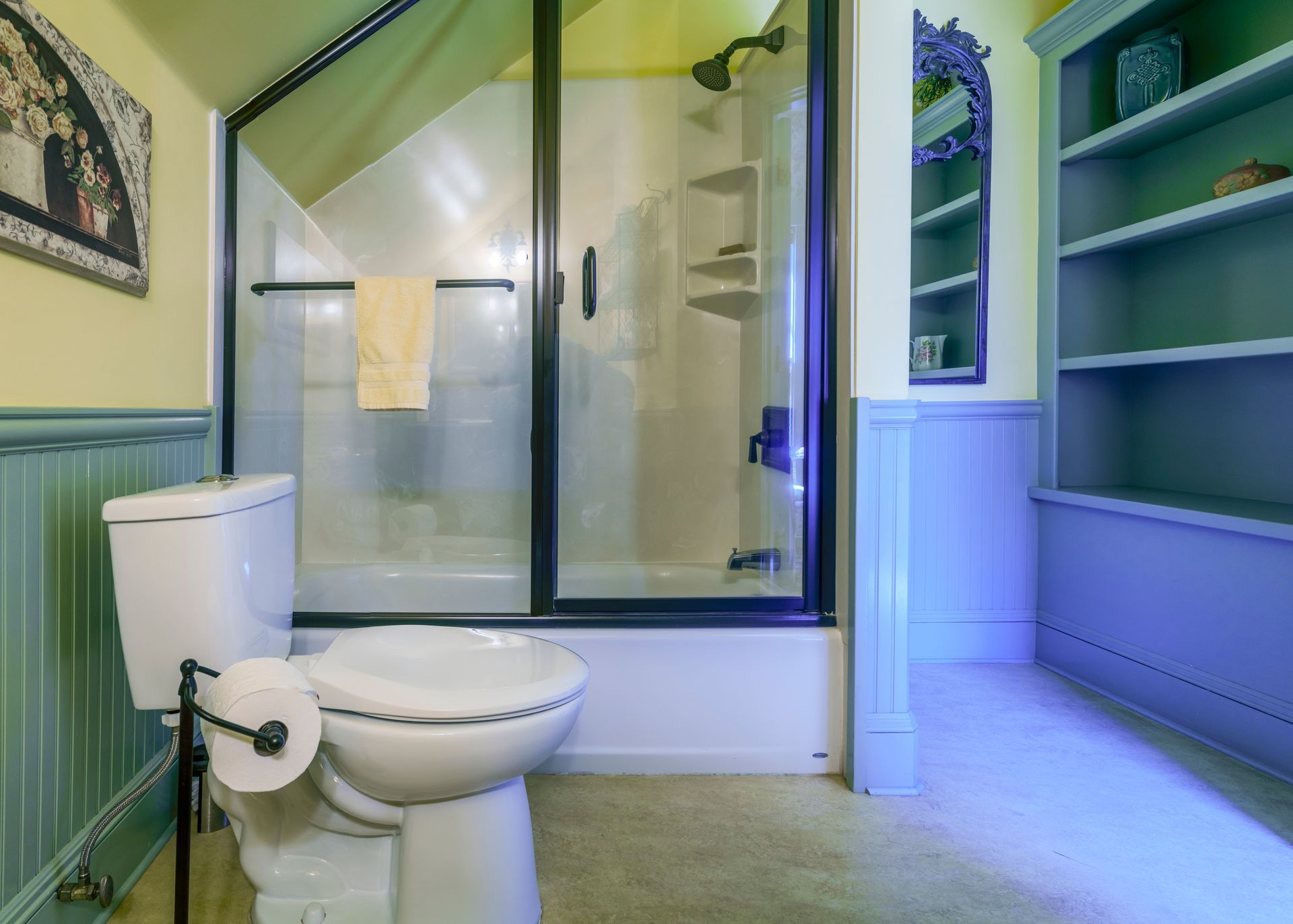 A bathroom with a toilet , tub and shower.