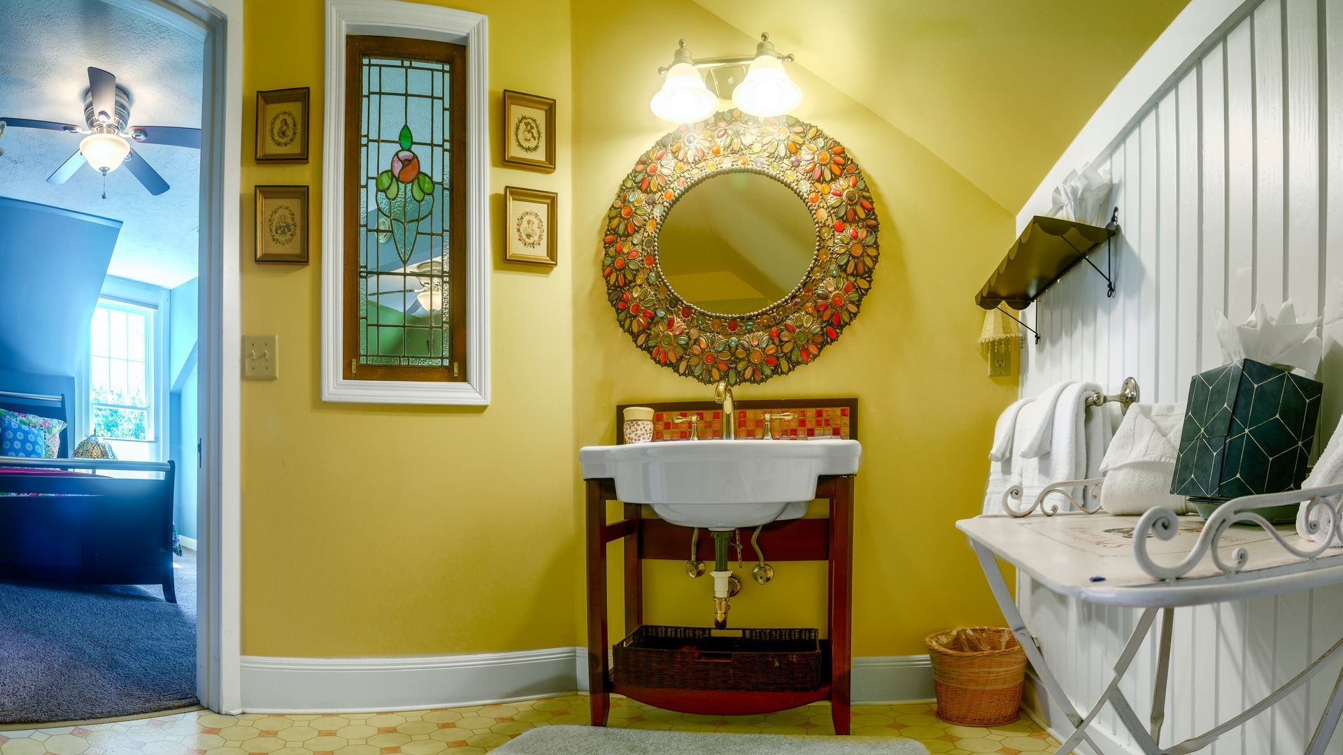 A bathroom with a sink and a mirror on the wall