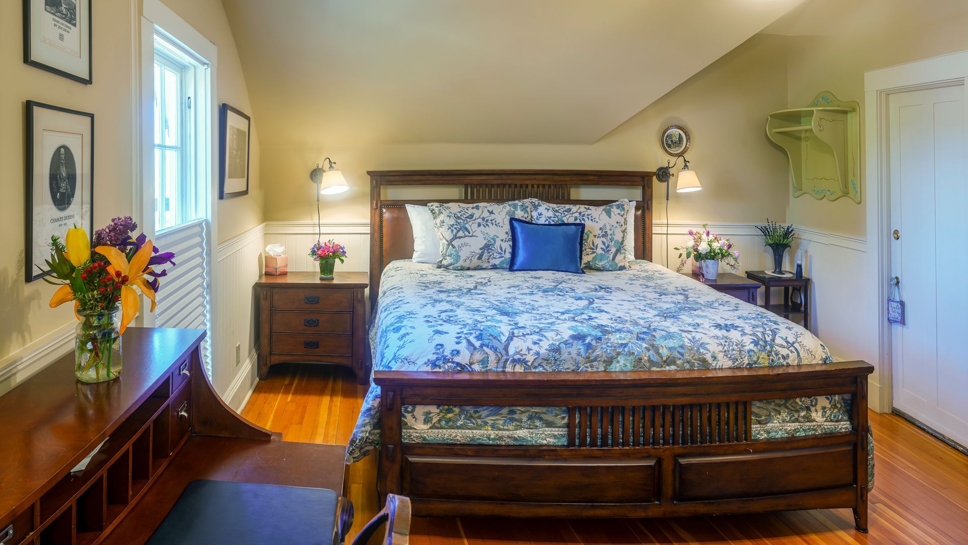 A bedroom with a large bed and a desk.