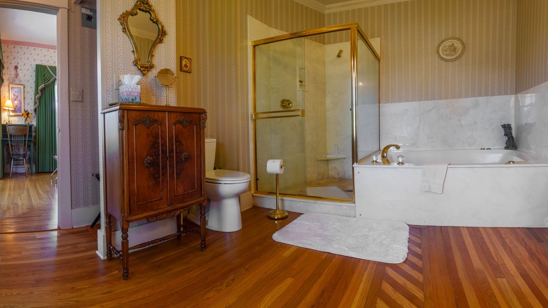 A bathroom with a toilet , sink , bathtub and shower.