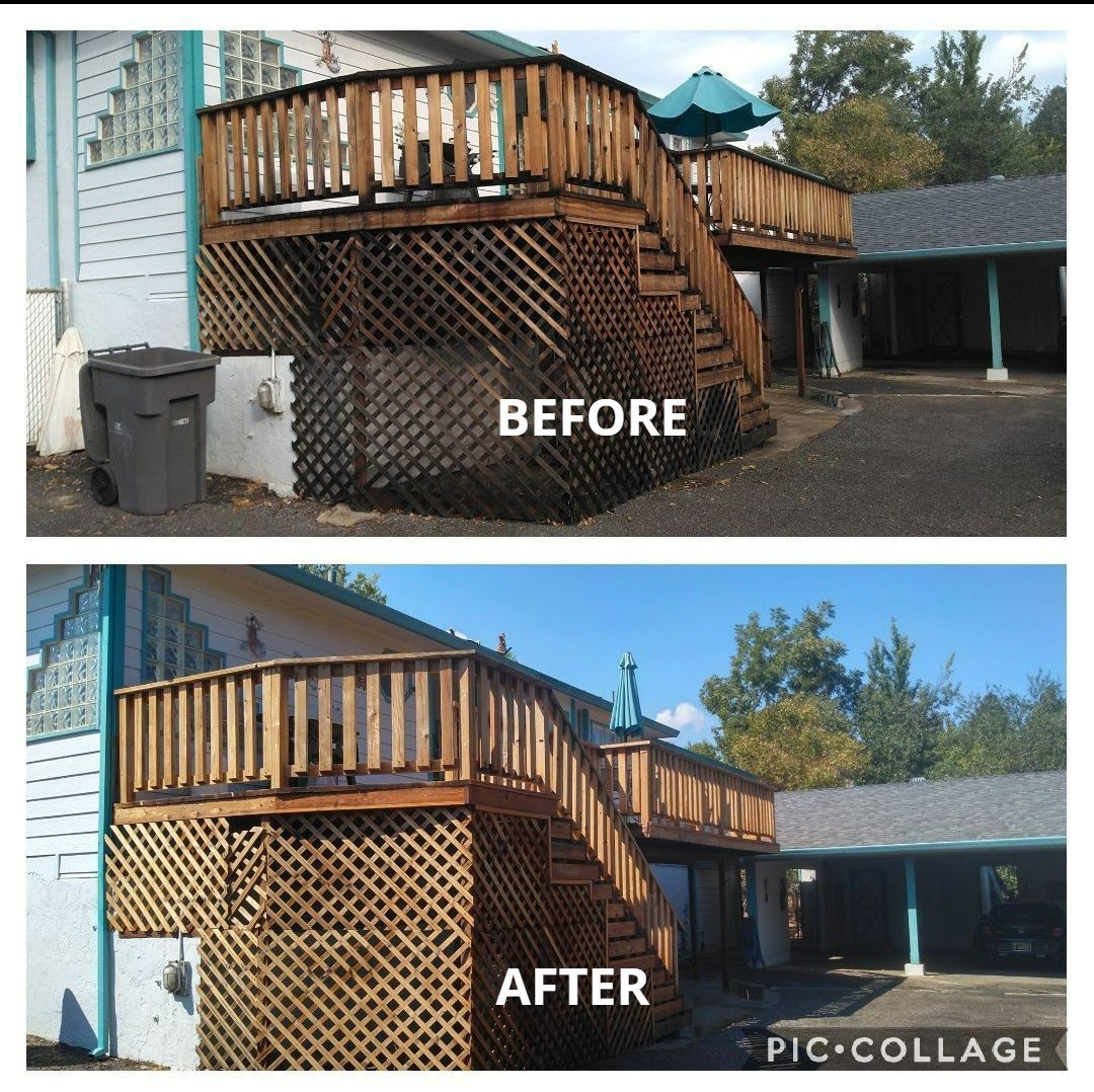 A row of yellow tractors are parked in a dirt field.