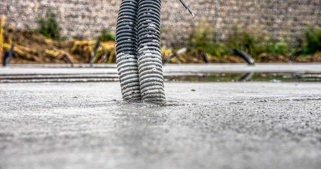 Wet concrete dries with foundation components in the slab.