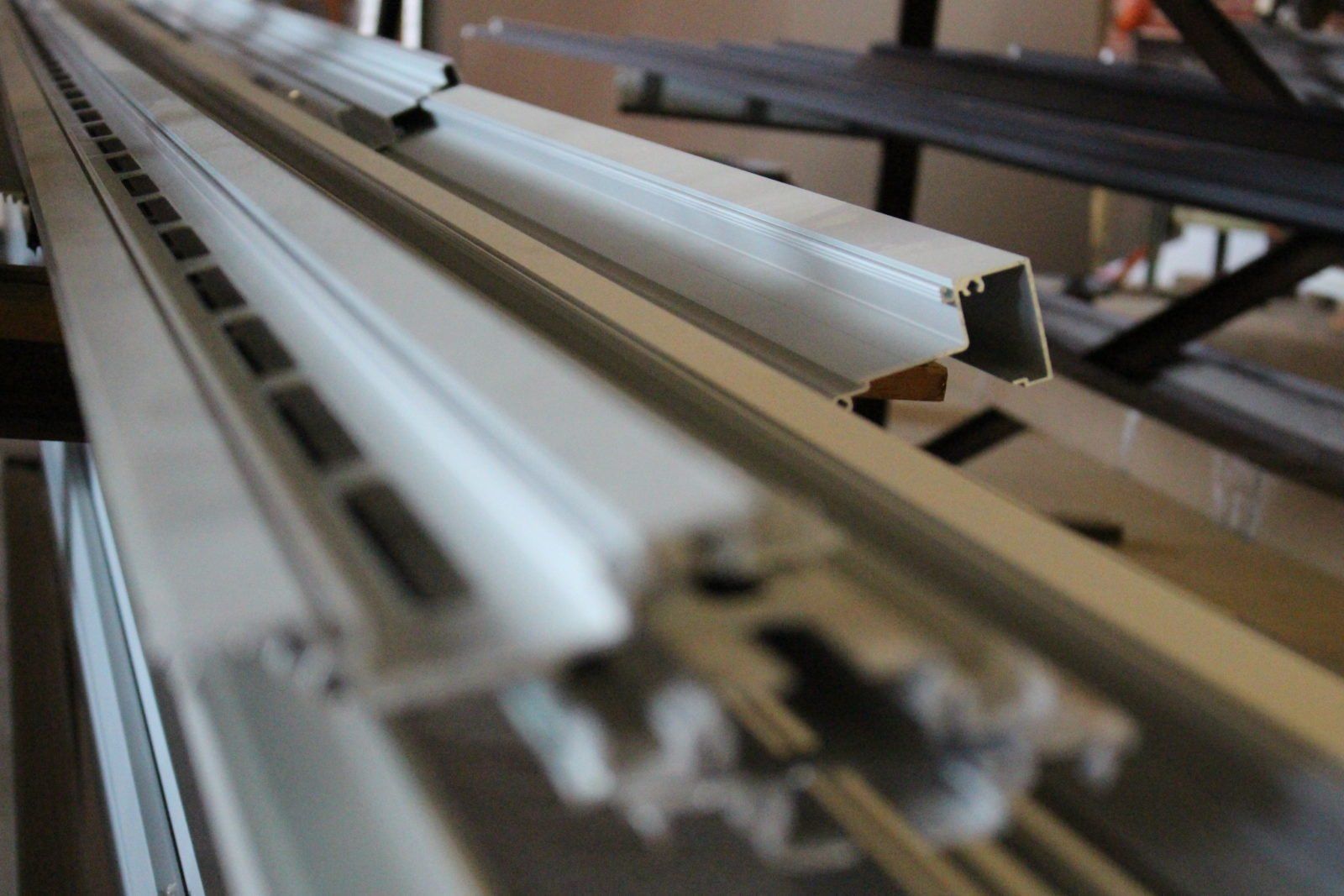 a row of white aluminum profiles are stacked on top of each other