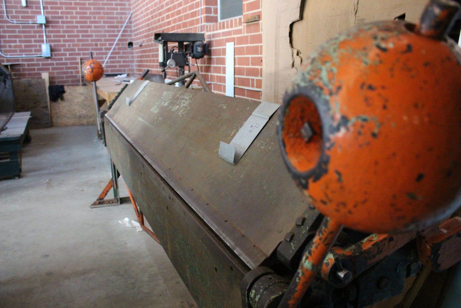 a machine in a room with a brick wall behind it