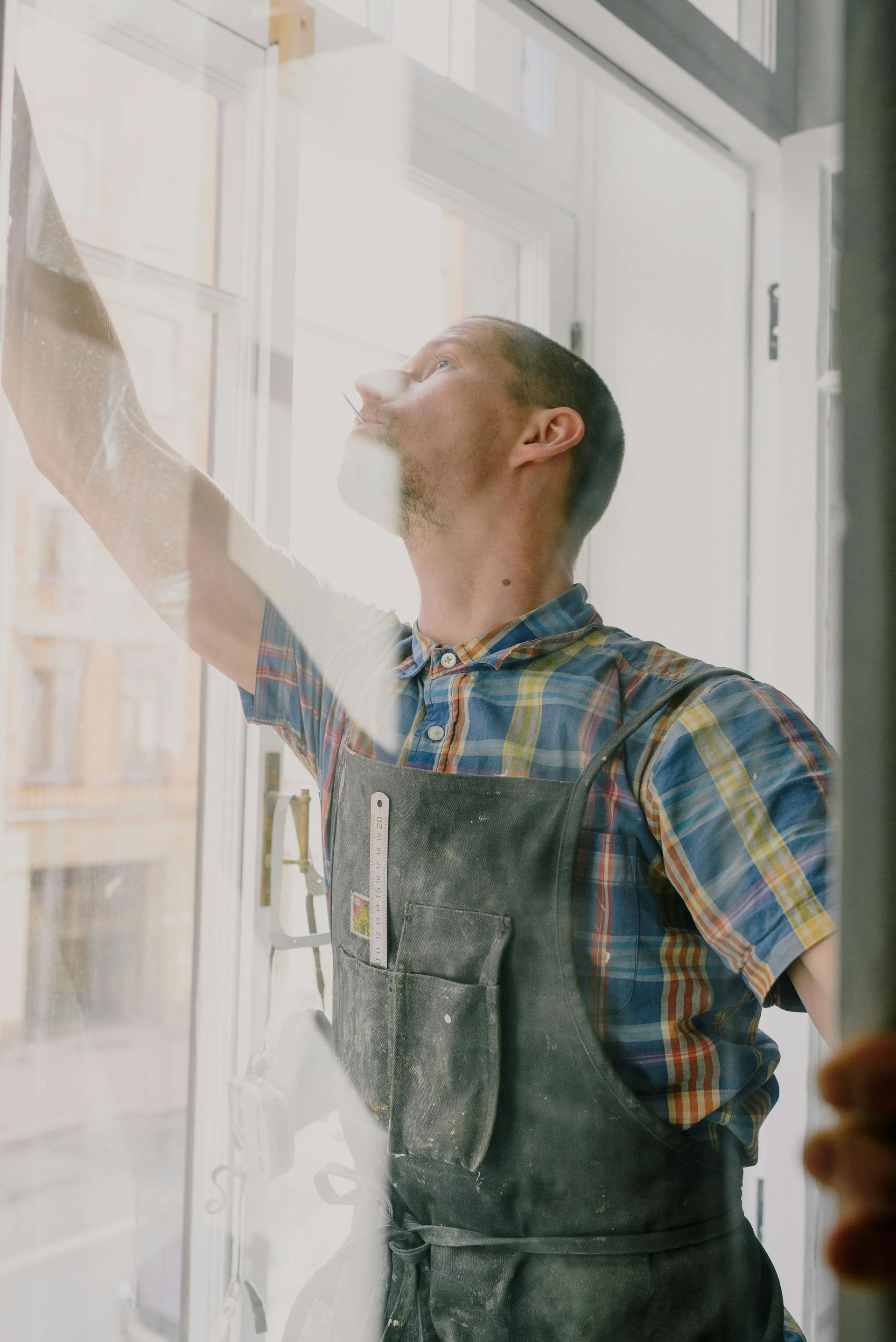 Middle-aged man working on glass windows