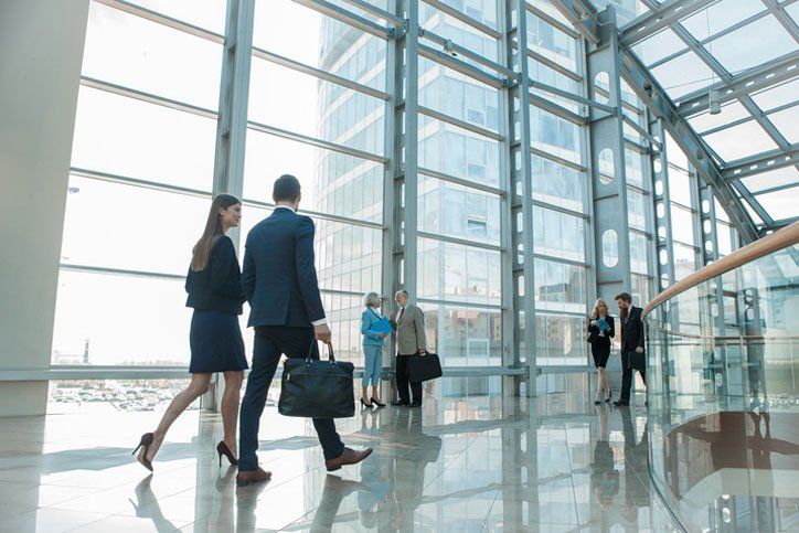 a group of business people are walking through a building