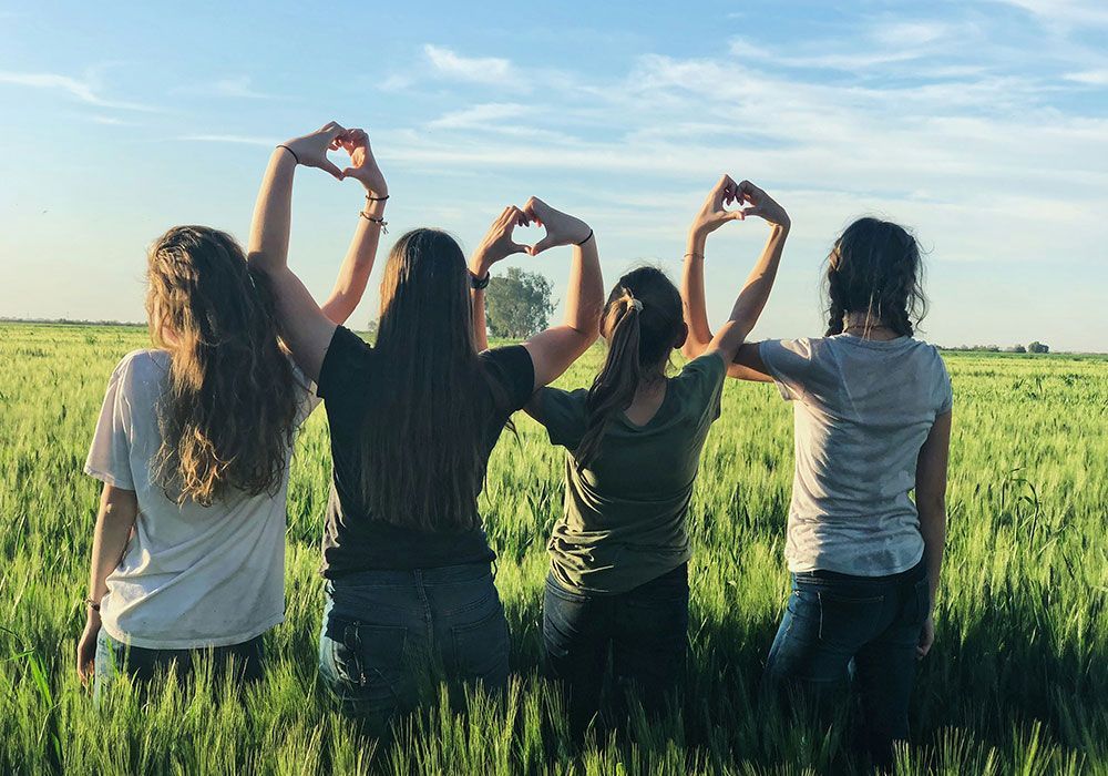 women forming heart gestures