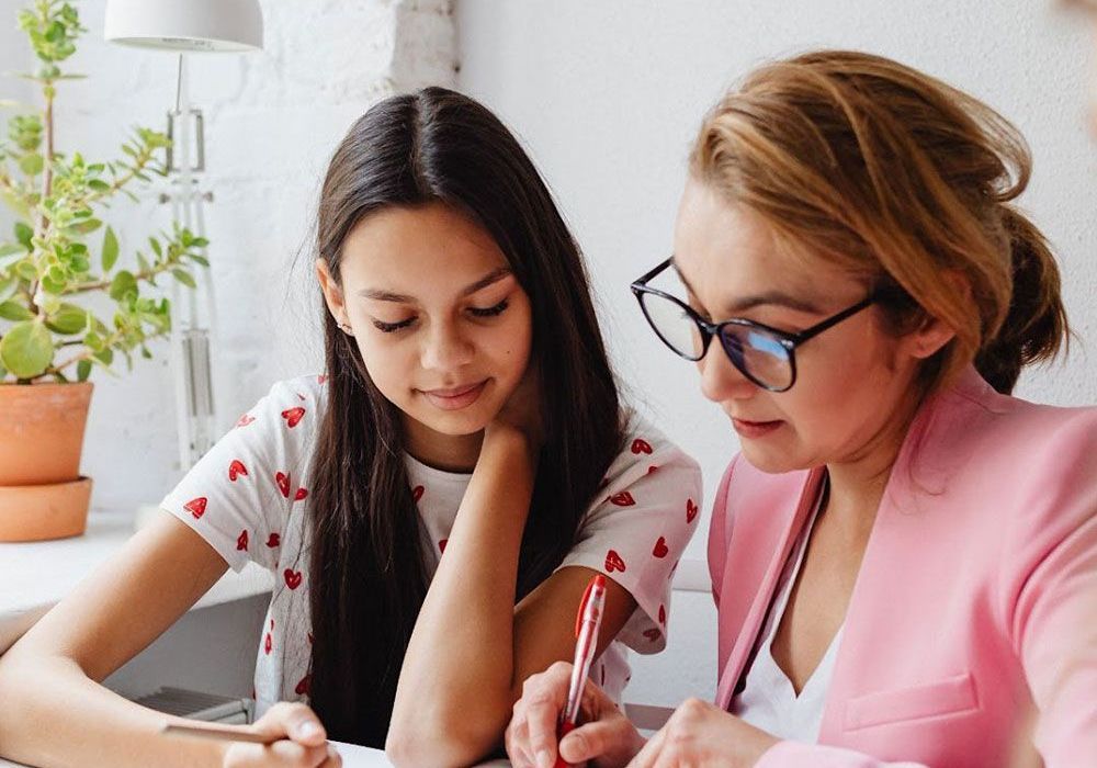 three women sitting on bench