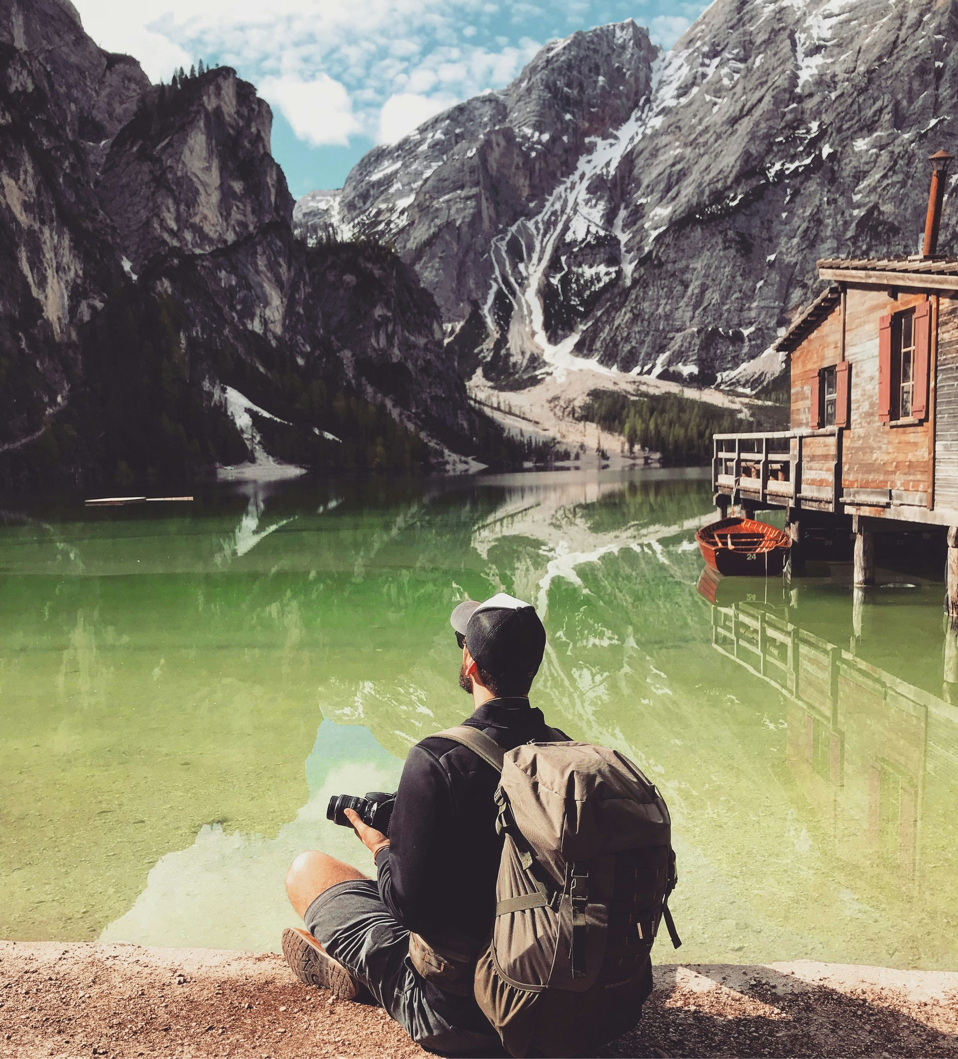 A man sitting near a lake 
