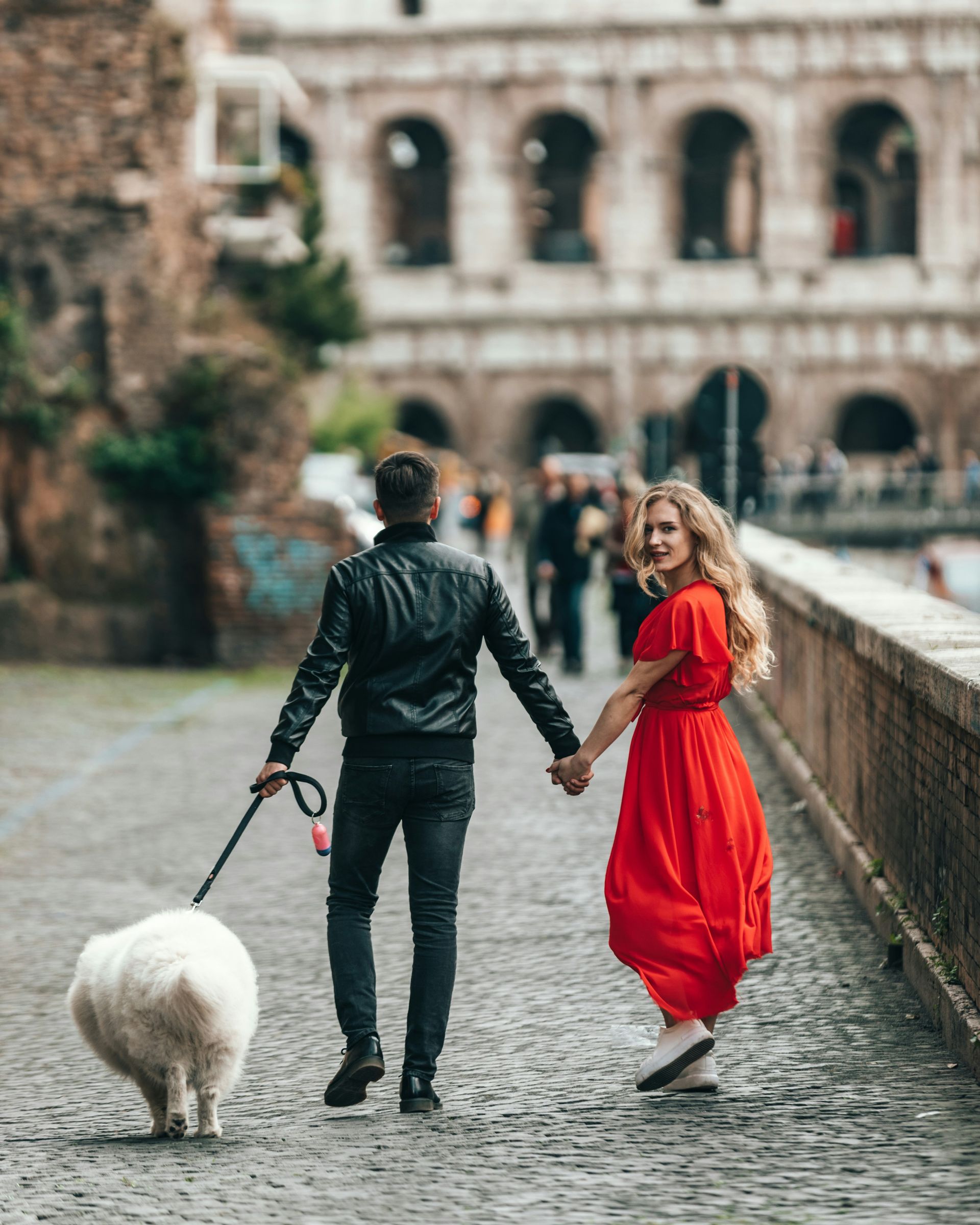 Couple with a dog walking in the street
