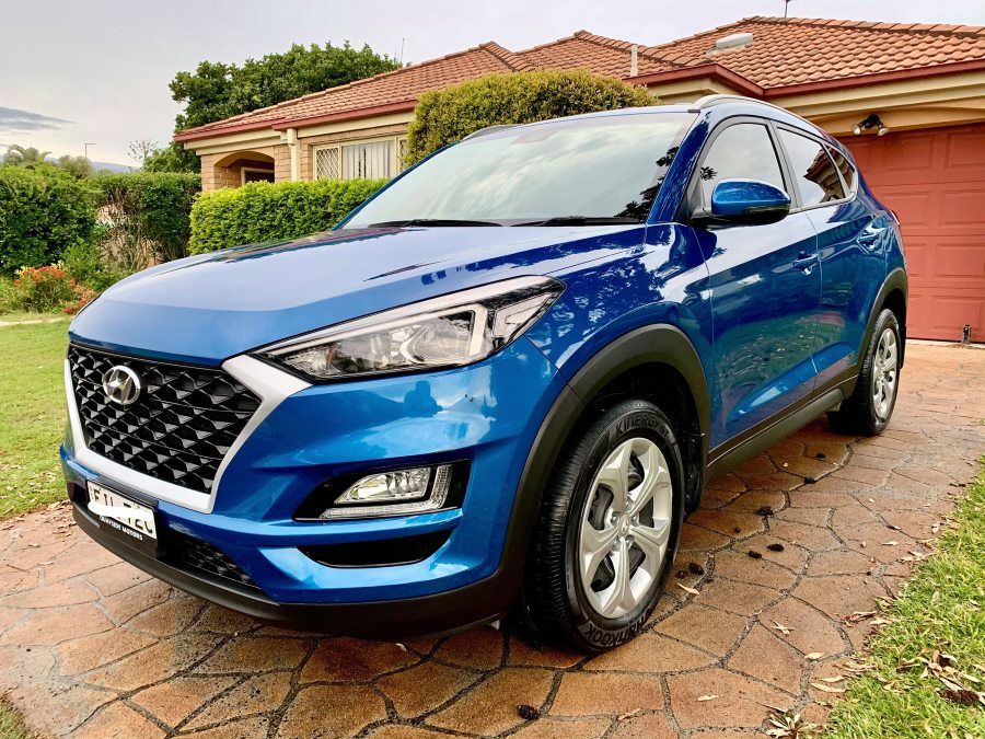 Blue Hyundai Tucson SUV Parked on a Paved Driveway in Front of a House — Clarence Valley Detailing In Coffs Harbour, NSW