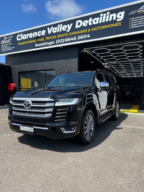 A Black Suv is Parked in Front of a Building — Clarence Valley Detailing In Yamba, NSW