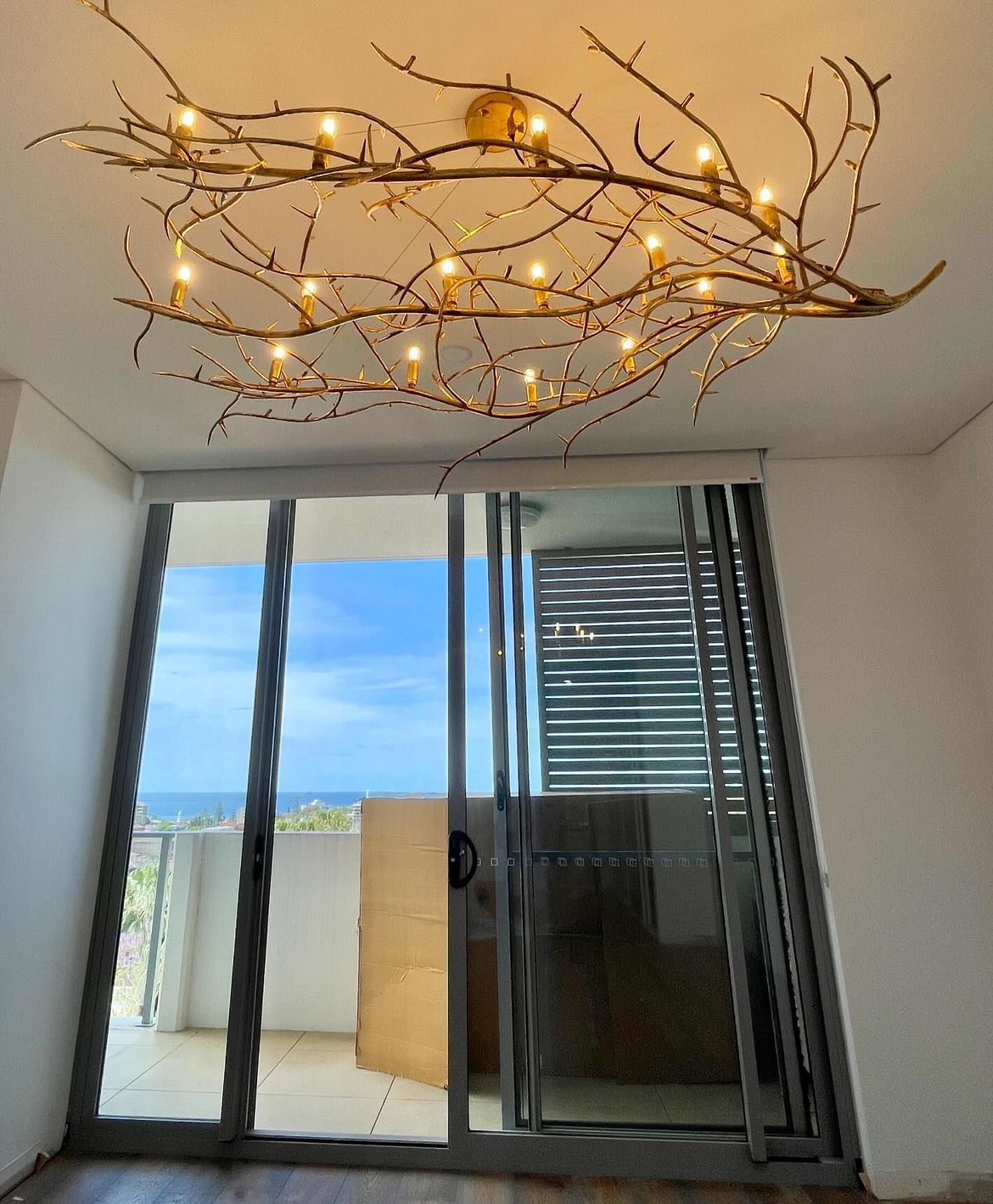 Electrician Is Holding A Light Bulb In His Hand — Luke Jones Electrical In Woonona, NSW