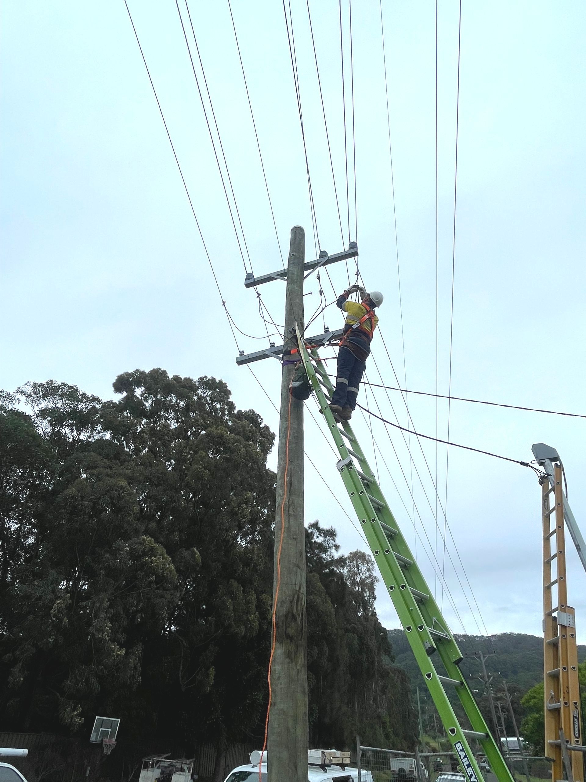 Electrician Working On An Electrical Panel At  Night — Luke Jones Electrical In Bellambi, NSW